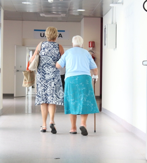 aging woman walking in medical facility